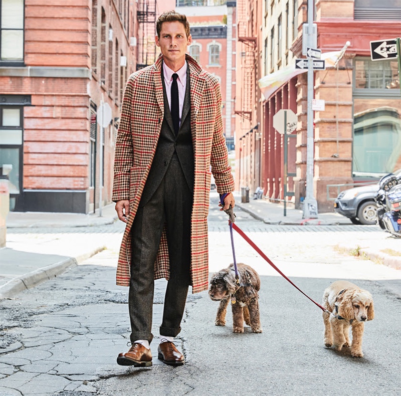 Out for a stroll, Roch Barbot dons a Todd Snyder Italian wool windowpane print topcoat $998 with a wool cashmere herringbone Sutton suit $786 in olive.