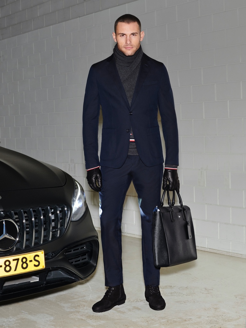 Corey Saucier suits up in a navy look from the Tommy x Mercedes-Benz fall-winter 2019 collection.