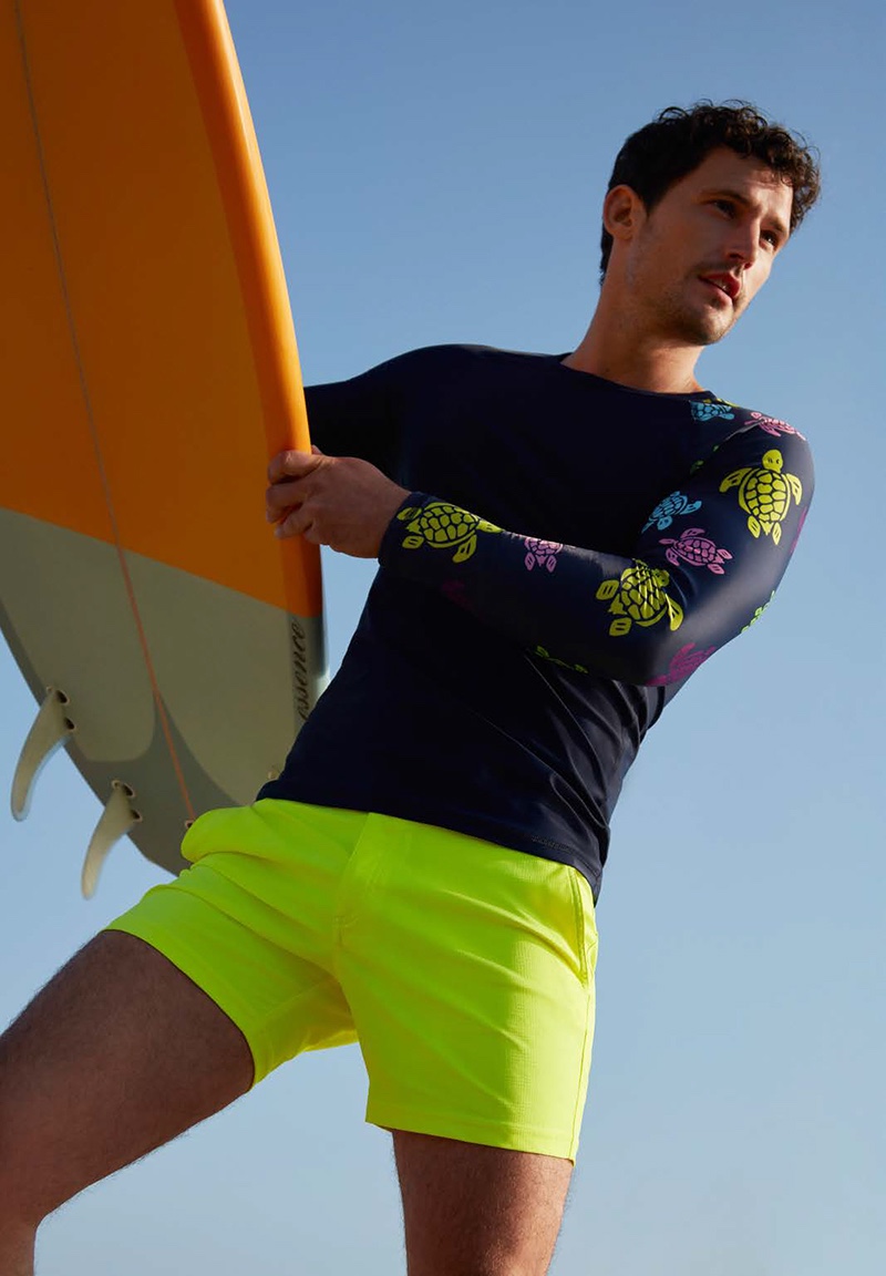 Sam Webb sports Vilebrequin's Rashguard Ronde des Tortues shirt $135 with neon yellow swim trunks $260.