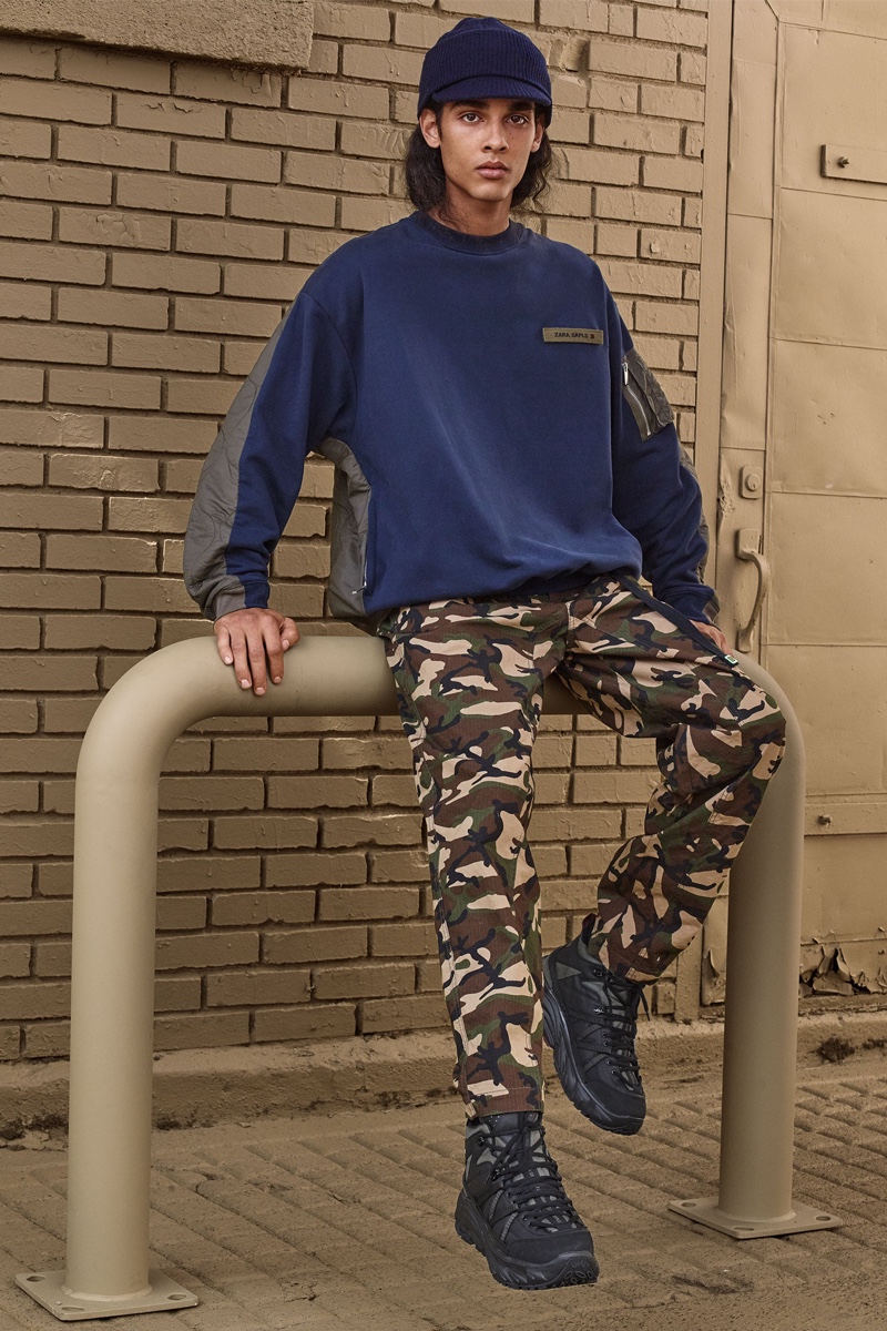 Jordy (Claude Management) wears a sweatshirt and camouflage print pants from Zara SRPLS' fall-winter 2019 collection.