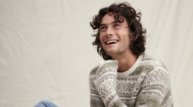 Oli Green Charms in Alex Mill Holiday '19 Collection All smiles, Oli Green sports a fairisle sweater with light wash denim jeans from Alex Mill.