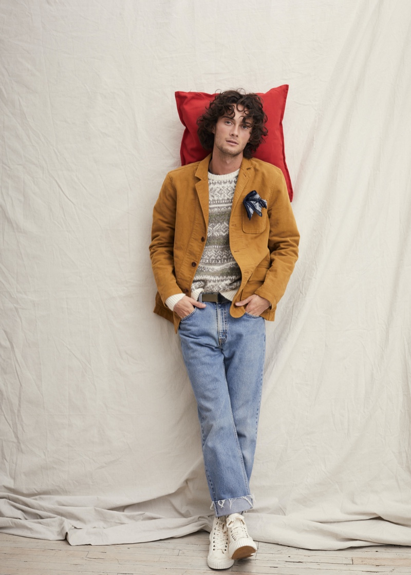 A smart vision, Oli Green wears an unlined blazer with a fairisle sweater and straight-cut denim jeans by Alex Mill.