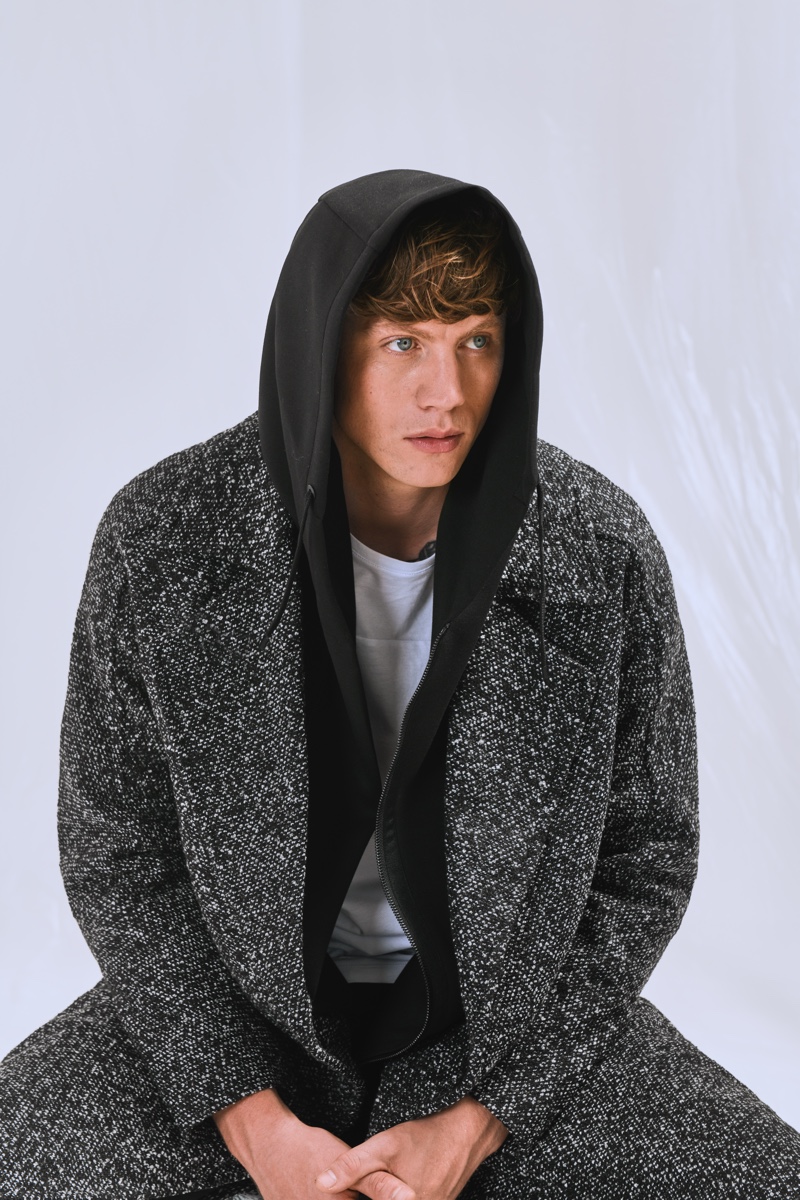 Sporting an oversized coat, Sid Ellisdon wears fashions from Antony Morato's "Open Mind" capsule collection. 