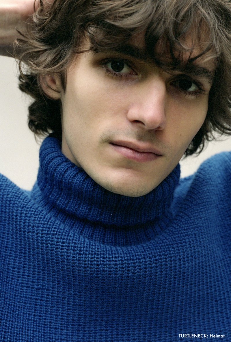 Model Massimo Colonna sports a blue turtleneck sweater by Heimat.