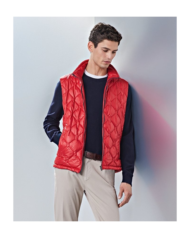 Connecting with BOSS, Arthur Gosse wears the brand's red quilted vest with khakis and a pullover.