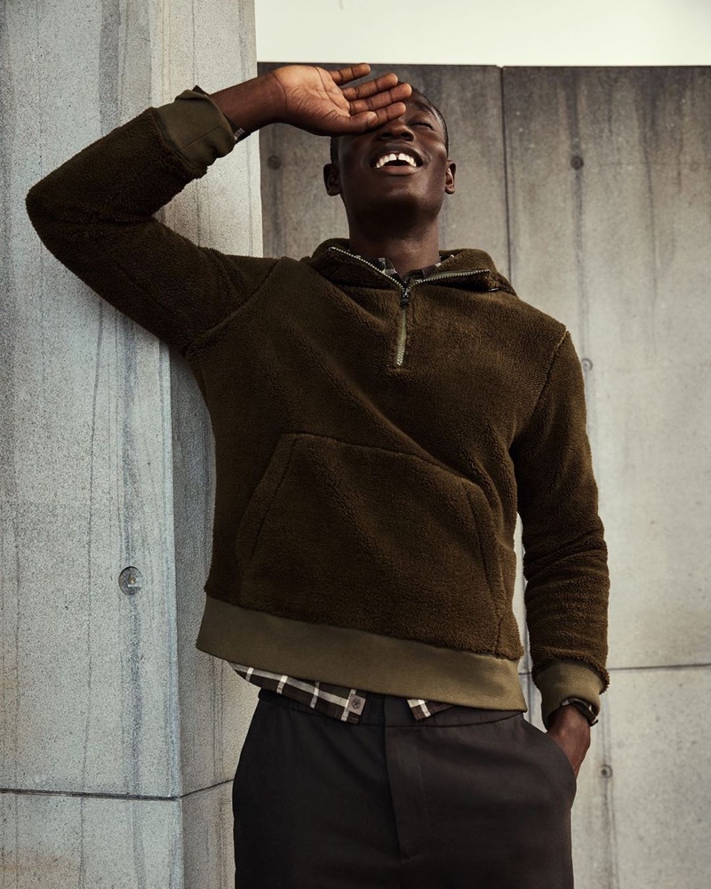 All smiles, Charles Oduro sports a brown fleece pullover from Banana Republic.