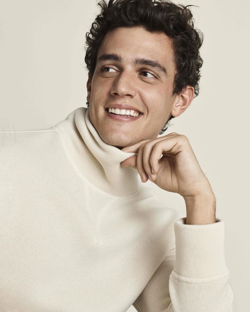 Smiling ear to ear, Xavier Serrano models a cozy knit from Banana Republic.