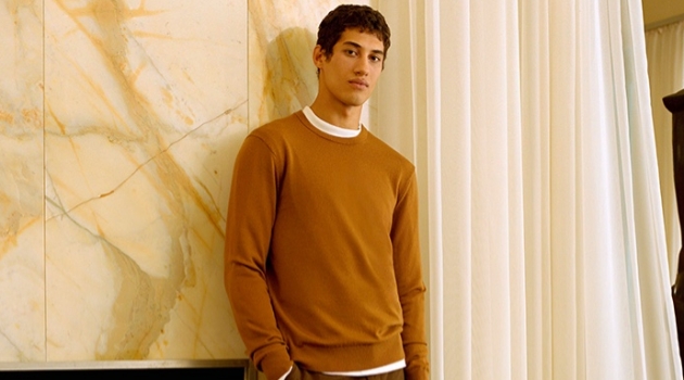 Seasonal Reflection: Malik Dons Chic Holiday Style for Club Monaco Malik Al Jerrari sports a brown sweater with wool flannel trousers from Club Monaco.