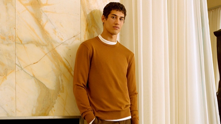 Malik Al Jerrari sports a brown sweater with wool flannel trousers from Club Monaco.