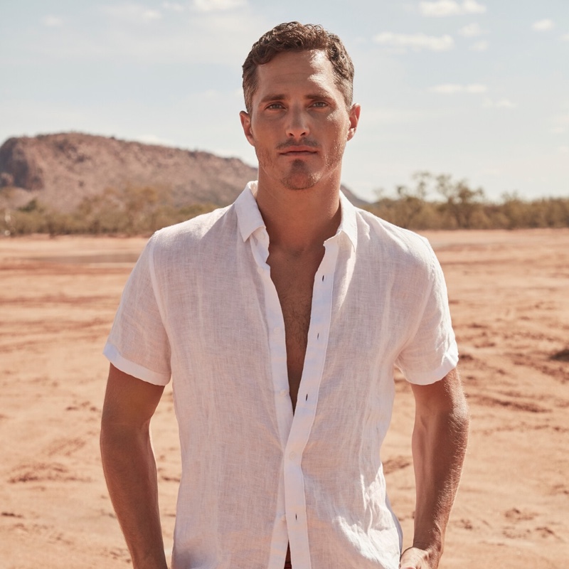 Ollie Edwards dons a white linen short-sleeve shirt from Country Road.