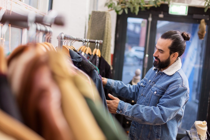 Denim Jacket Wearing Man Shopping Second Hand Store