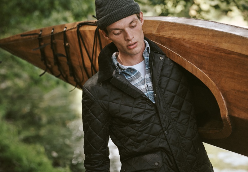 Model Rocky Harwood dons a Barbour plaid shirt and quilted jacket with a POLO Ralph Lauren pocket tee.