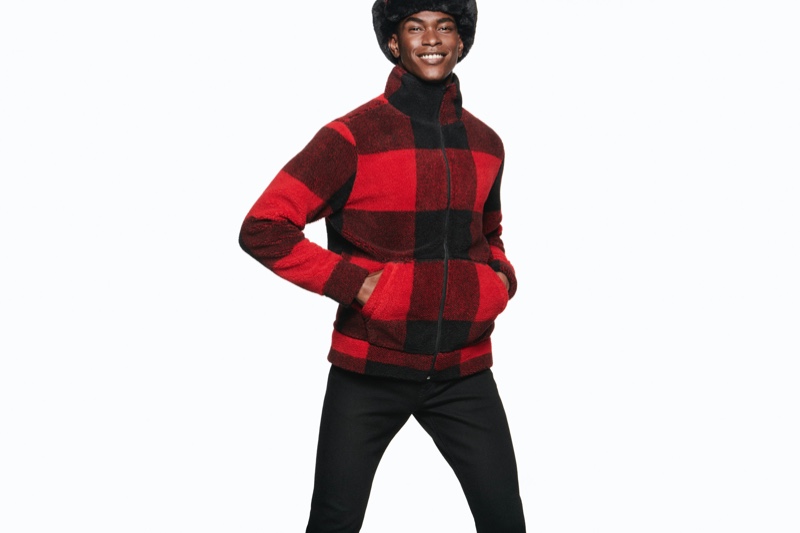 Rocking a red and black buffalo check jacket, Salomon Diaz spreads joy with Express' holiday 2019 campaign.