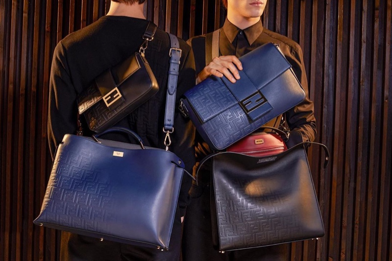 Models Yang Hao and Liam Kelly pose with Fendi's covetable bags for the season.