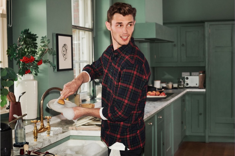 Doing the dishes, Kit Butler sports a H&M regular fit flannel shirt.