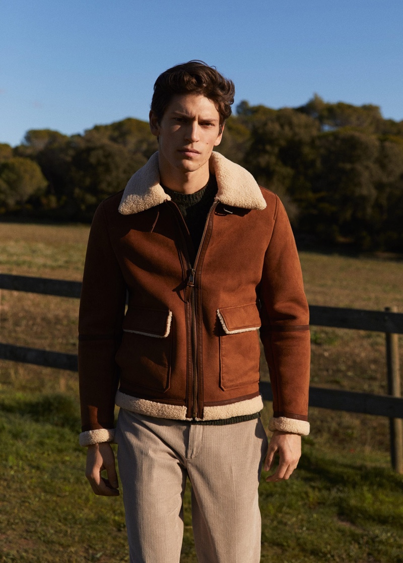 Model Justin Eric Martin rocks a brown faux suede jacket from Mango with corduroy pants.