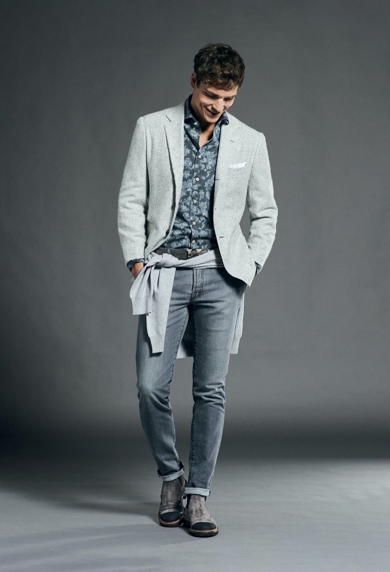 Taking to the studio, Alexandre Cunha dons a chic gray ensemble from Kiton.