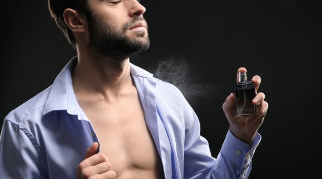 Men's Guide: How to Make the Scent of Your Cologne Last Longer Man Spraying Cologne