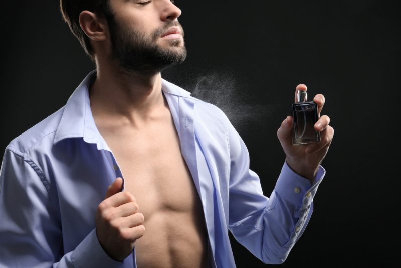 Man Spraying Cologne