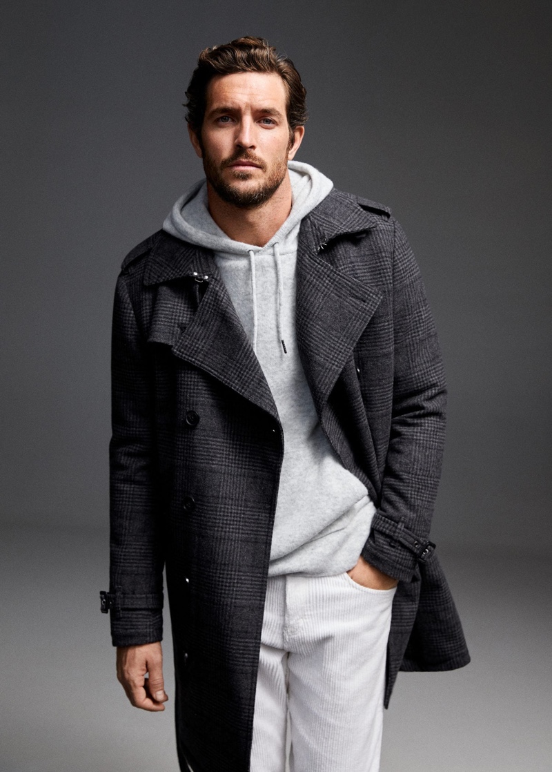 Going for a casual chic look, Justice Joslin dons an overcoat with a hoodie and corduroy pants by Mango.