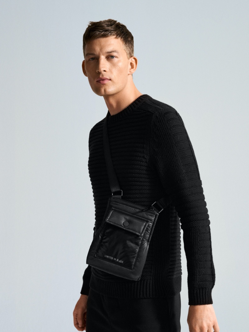 Front and center, Bastian Thiery models a ribbed sweater and bag from Marc O'Polo.