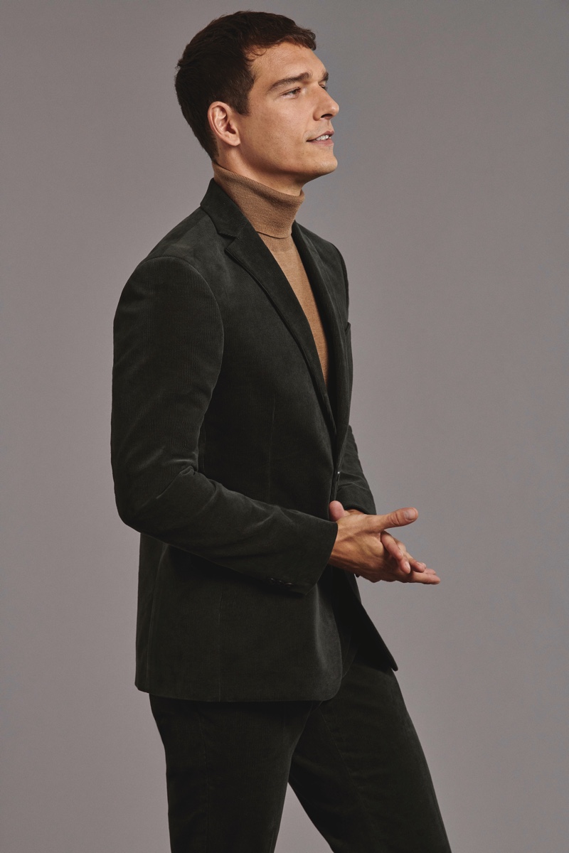 A chic vision, Alexandre Cunha sports a velvet suit with a turtleneck sweater from Marks & Spencer.