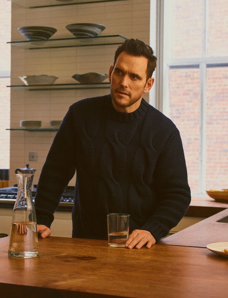 Pictured in the kitchen, Matt Dillon sports a navy cable-knit sweater by Brioni.