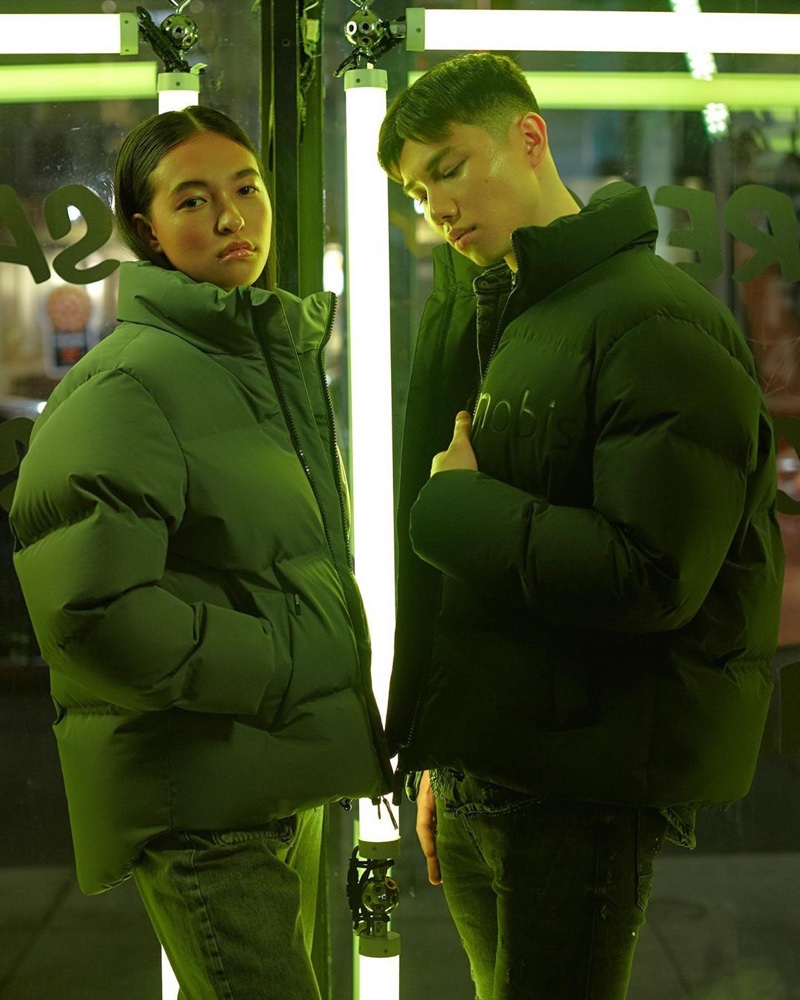 Madelaine Violi and Sean Kemp model Nobis' limited-edition puffer jackets for Black Friday.