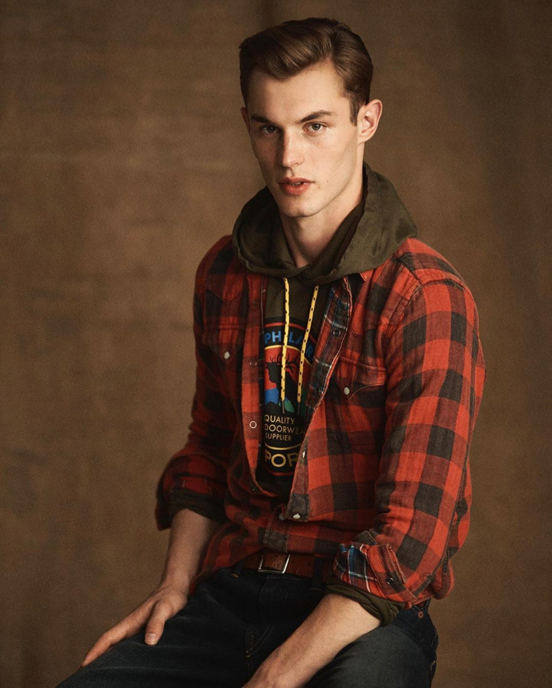 Kit Butler sports a red flannel shirt and hooded pullover from the POLO Sport Ralph Lauren collection.