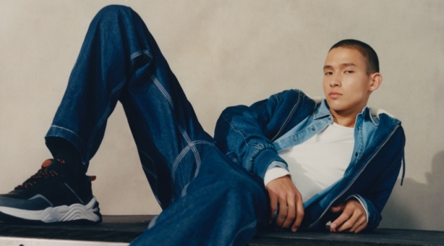 Tommy Doubles Down on Denim for Pull & Bear Campaign Posing for a photo, Tommy Vanden Meerssche sports a hooded denim jacket, shirt, and jeans from Pull & Bear.