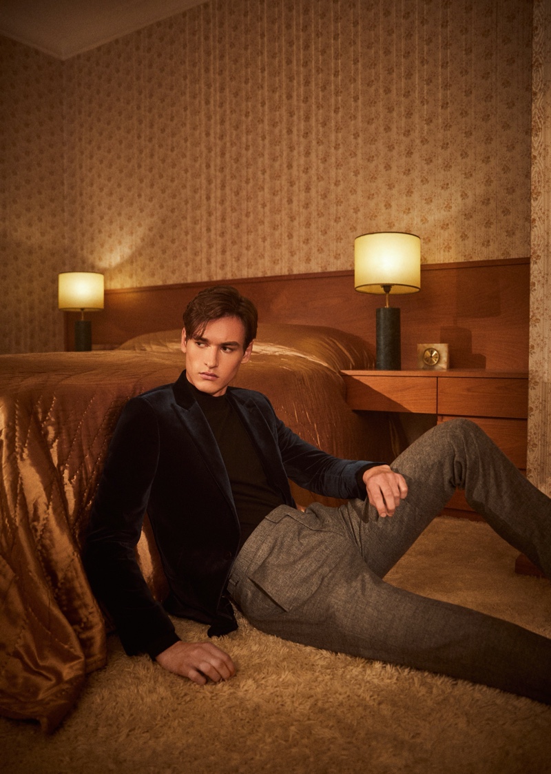 Front and center, Jegor Venned sports a green velvet blazer with a wool sweater and checked trousers by Reiss.