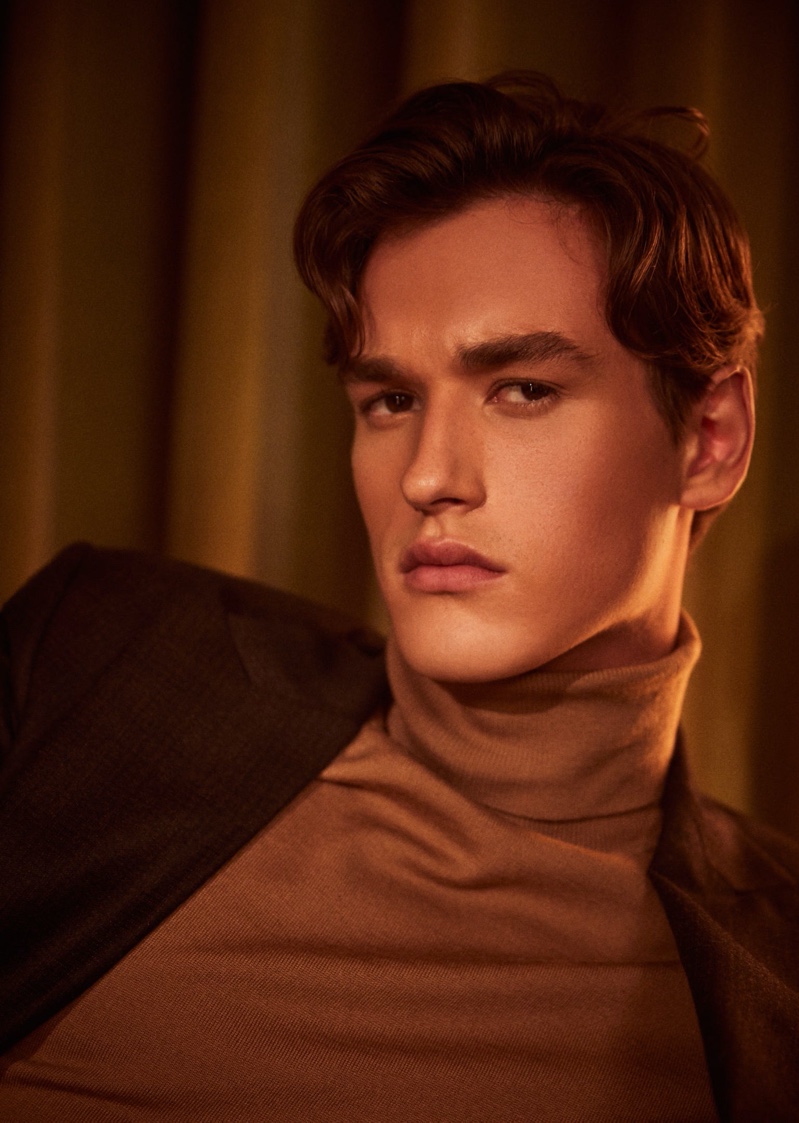 Donning a turtleneck and suit jacket, Jegor Venned connects with Reiss to showcase its partywear. 