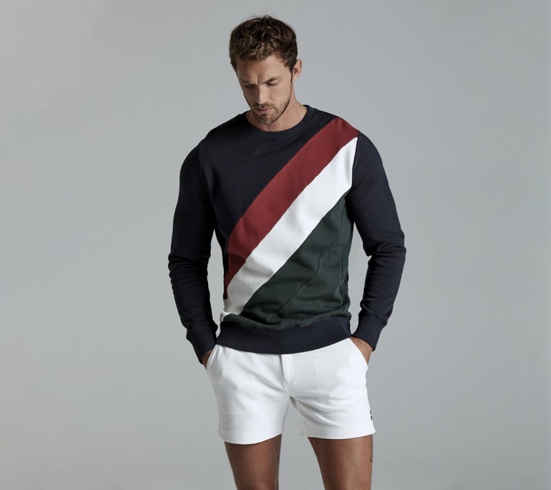 Front and center, Christian Hogue sports a colorblock sweatshirt and shorts from Ron Dorff.