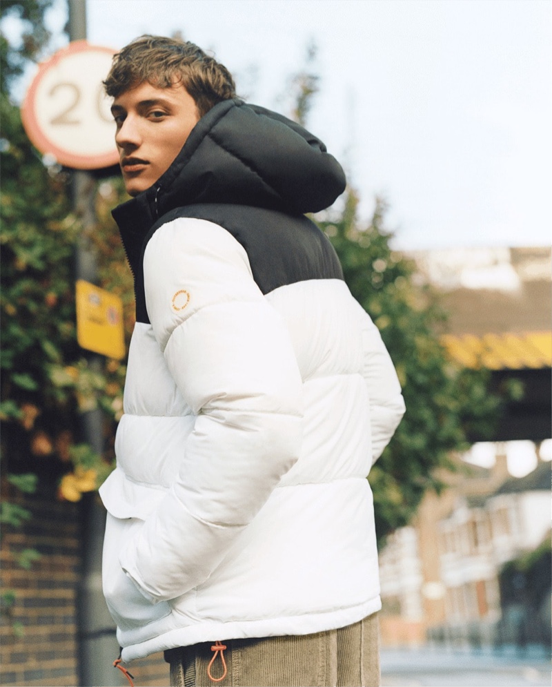 Model Serge Rigava dons a puffer jacket with corduroy pants by Bershka.