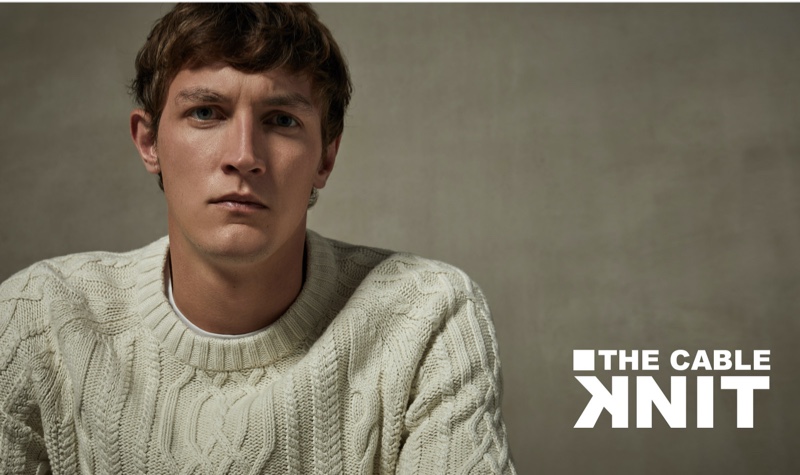 Connecting with Sfera, Rutger Schoone wears an off-white cable-knit sweater.