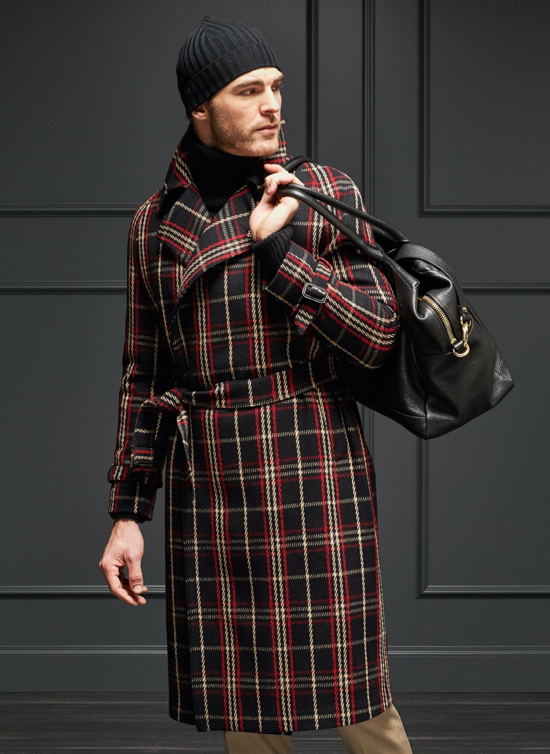 Making a checked statement, Patrick Kafka sports a coat from Tagliatore. 