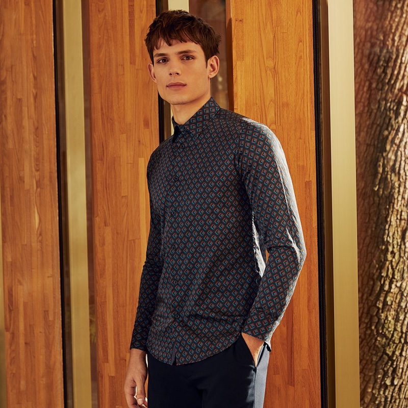 Making a graphic statement, Adrian Sotiris wears Ted Baker's Glacee geo print shirt $165.