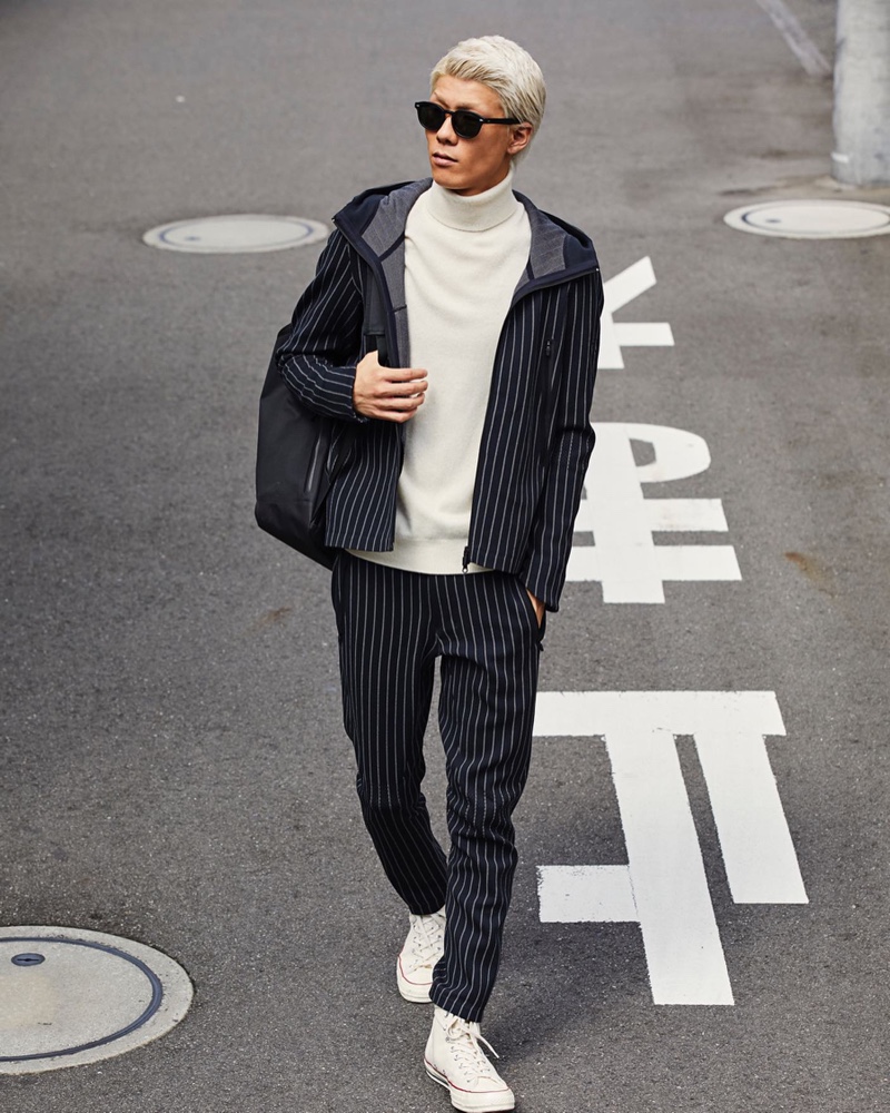 A smart and modern vision, Jumpei models a Todd Snyder + Descente navy pinstripe hoodie jacket $370 and long pants $320.