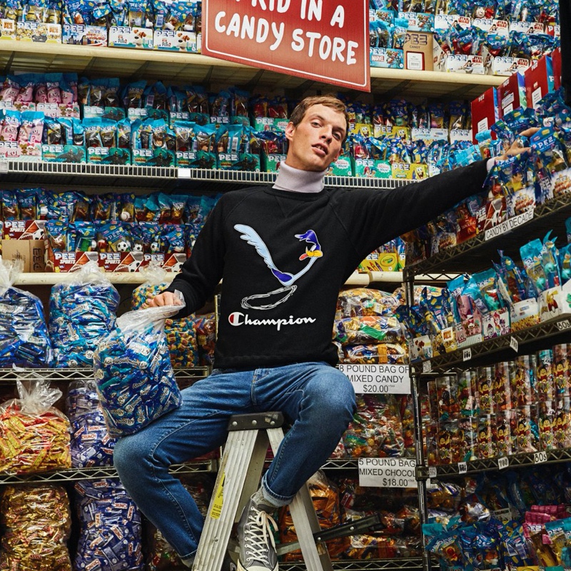 Pictured in a candy store, Rocky Harwood models a Todd Snyder + Champion + Looney Tunes Roadrunner "Beep Beep" reverse weave sweatshirt $178 in black.