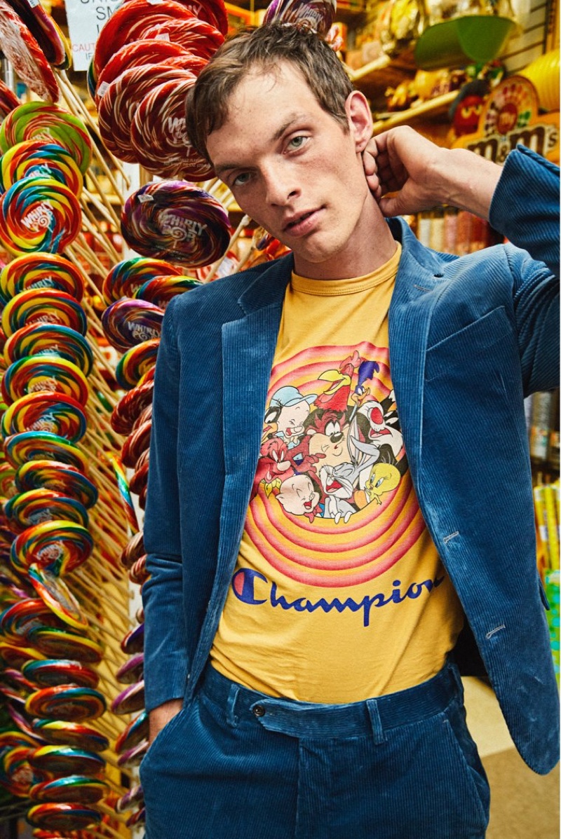 Embracing a pop of color, Rocky Harwood wears a Todd Snyder + Champion + Looney Tunes gang tee $88 in warm gold.