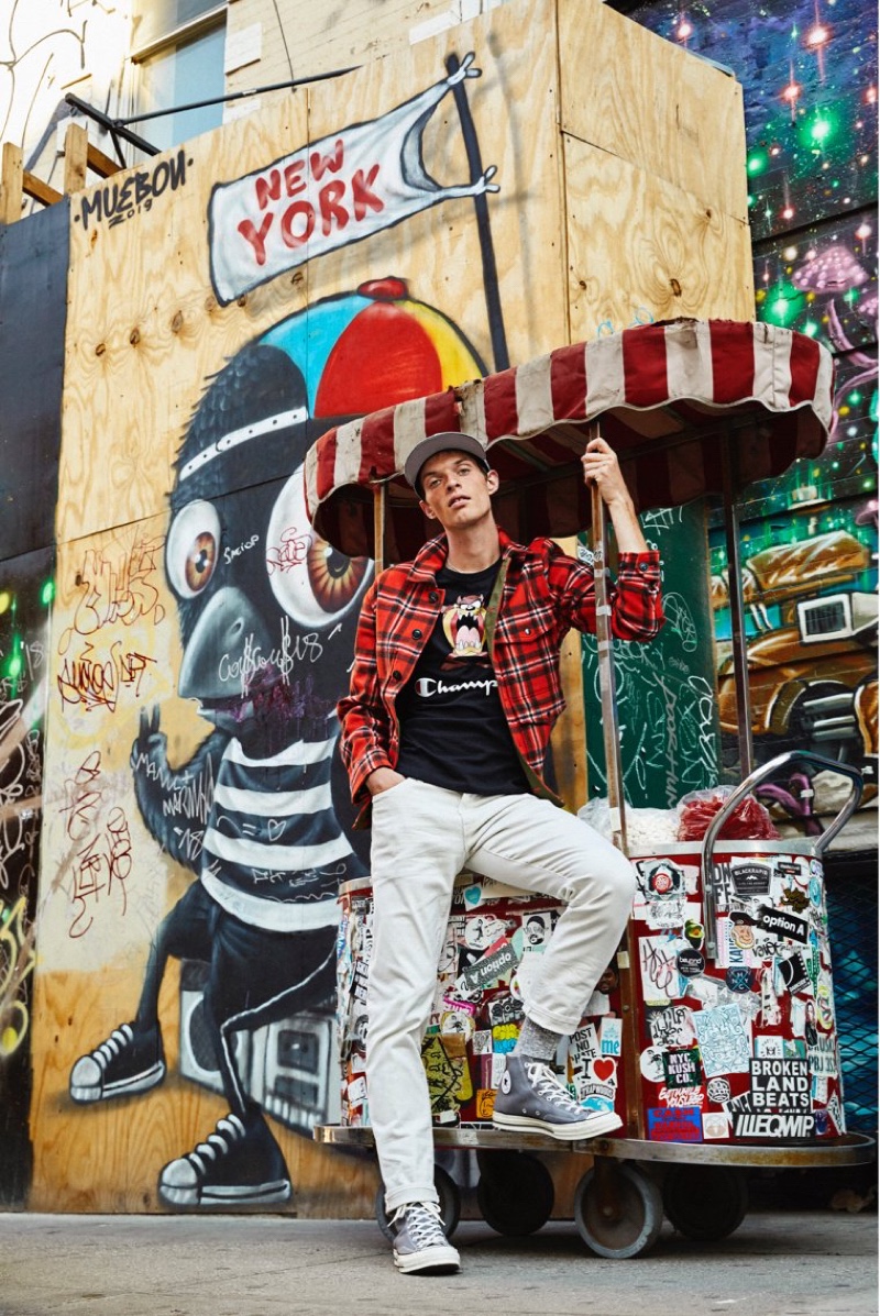 Posing on the New York City streets, Rocky Harwood wears a Todd Snyder + Champion + Looney Tunes Tasmanian Devil tee $88 in black.