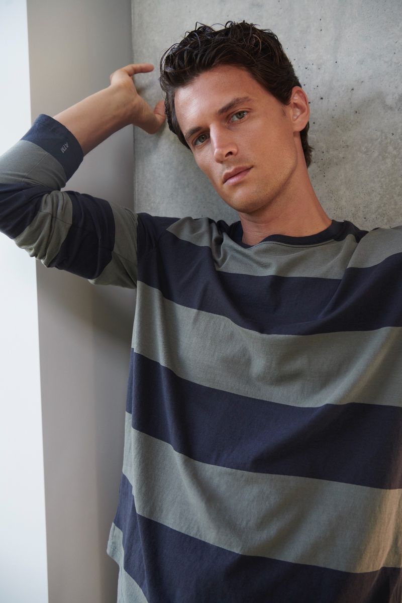 Embracing essential style, Garrett Neff wears a striped long-sleeve tee by ATM.