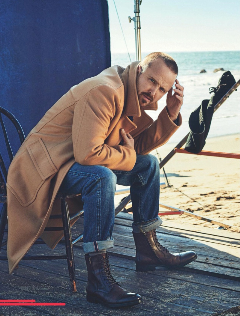 Starring in a photo shoot for Men's Journal, Aaron Paul sports a Mr P. coat, The Workers Club Denim Jeans, and Kenneth Cole boots.