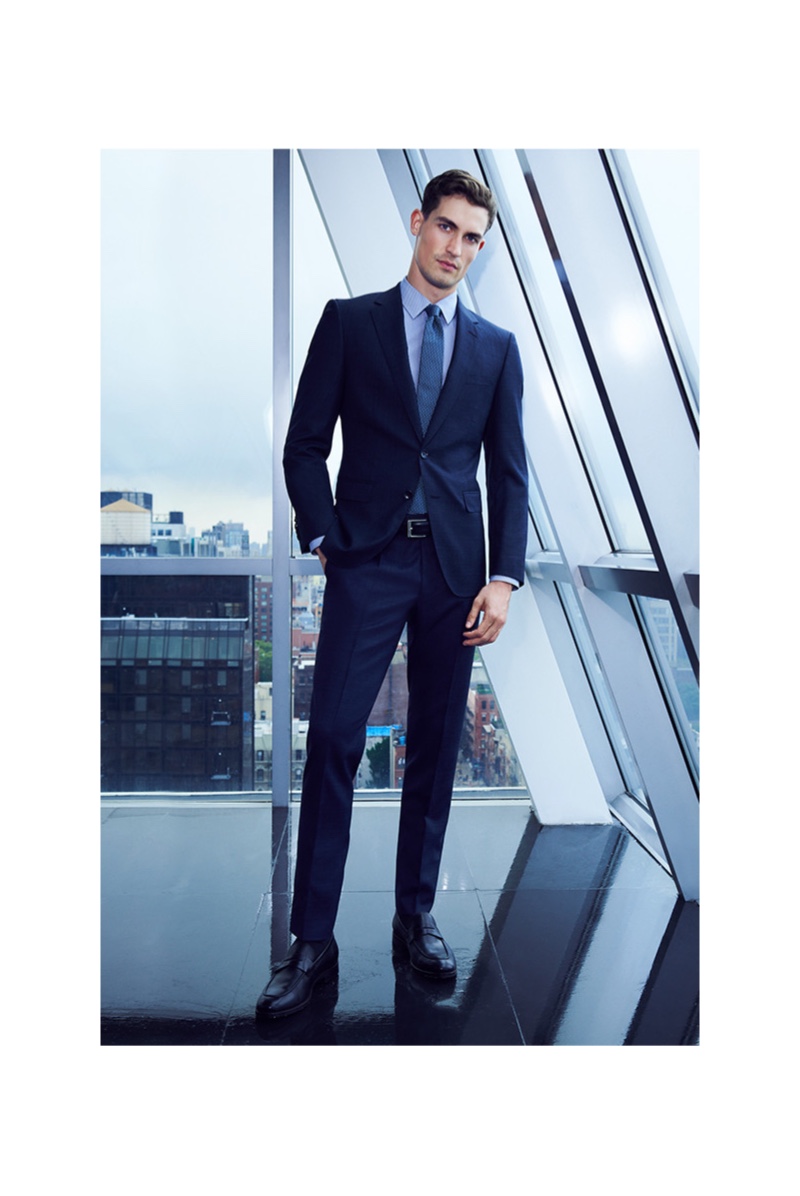 Front and center, Jason Anthony cleans up in a sleek navy BOSS suit for Bloomingdale's.