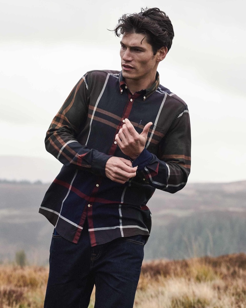 Taking to the outdoors, Sam Way dons a plaid shirt from Barbour's latest men's collection.