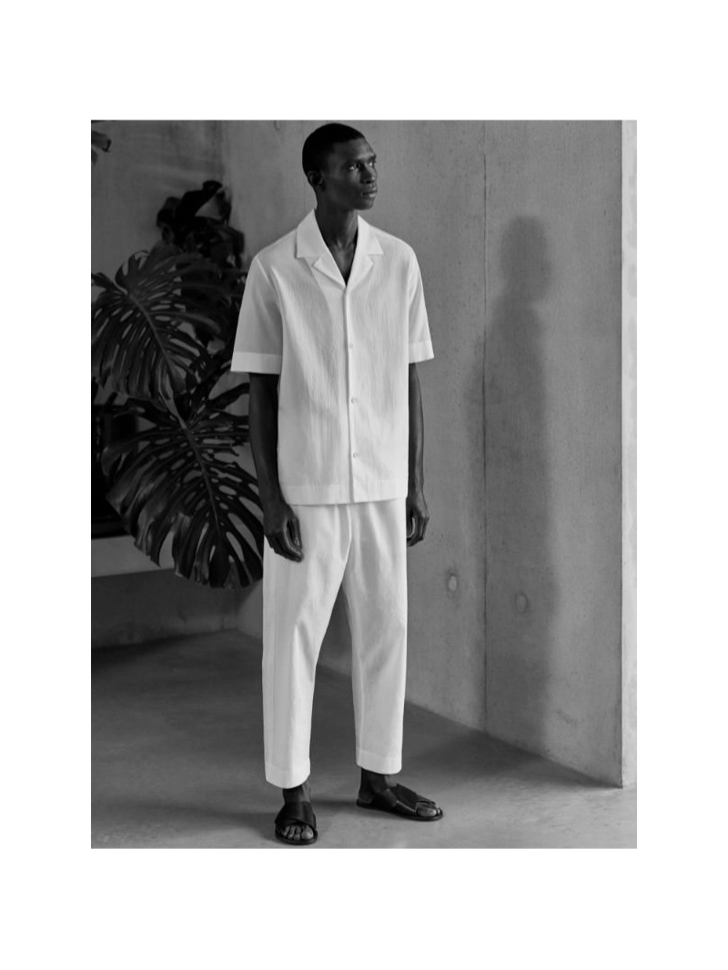 Taking to the studio, Fernando Cabral wears a COS short sleeved cotton shirt and pants.