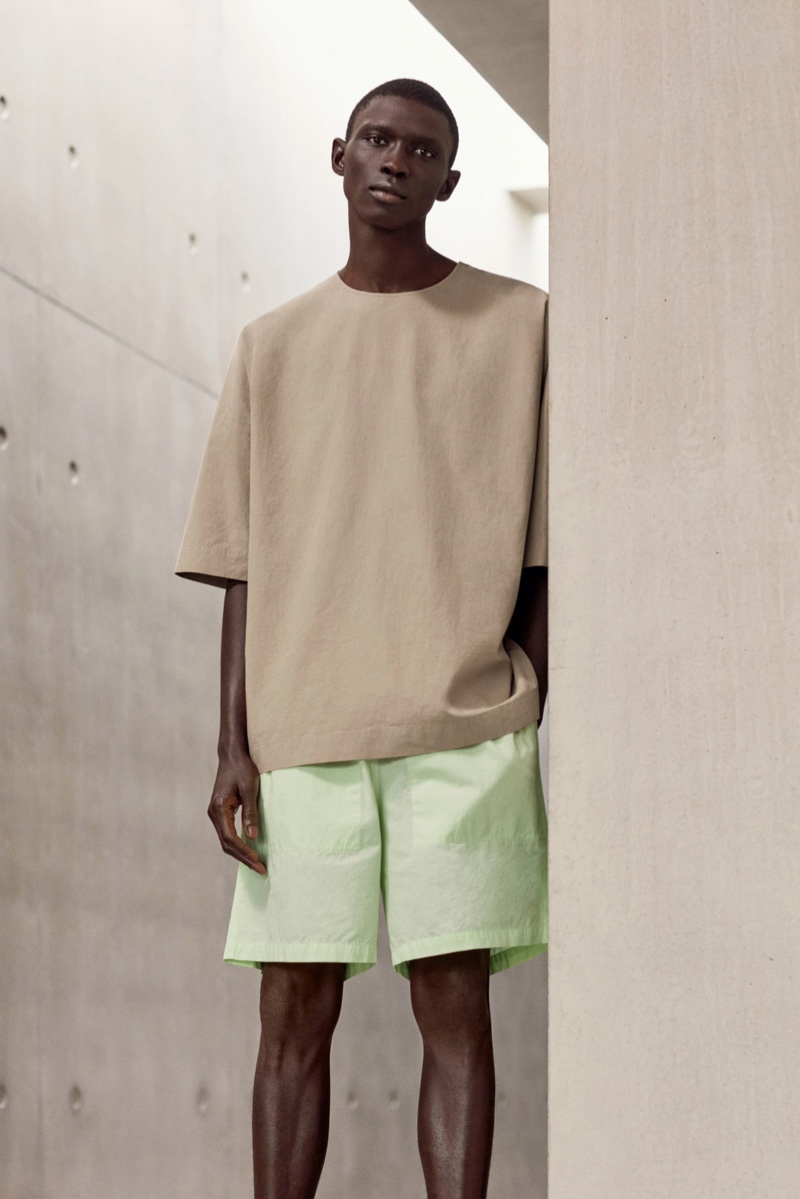 Front and center, Fernando Cabral wears an oversized cotton top and boxy shorts from COS.