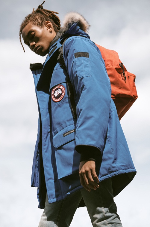 Model Seth Hill ventures outdoors in a blue Canada Goose PBI expedition parka, Levi's Red Tab skinny fit 510 denim jeans, and an Eastpak padded Pak'r backpack.