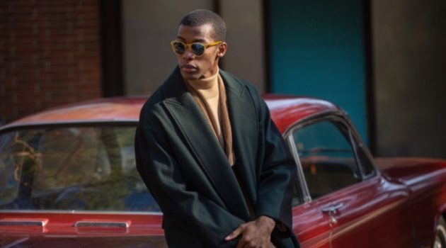 Magor Meng Dons Smart Holiday Style for East Dane Magor Meng wears a BOSS corduroy sportcoat with an A.P.C. turtleneck sweater, Maison Kitsune wrap coat, and Persol PO3152S sunglasses.