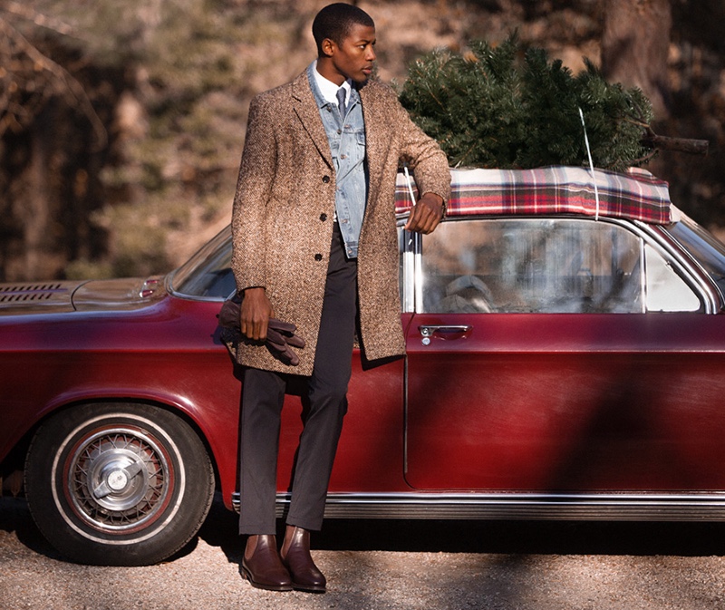 A smart vision, Magor Meng dons a BOSS herringbone topcoat and micro print tie. He also models a Madewell denim jacket, POLO Ralph Lauren poplin shirt, Theory trousers, R.M. Williams boots, and Filson gloves.